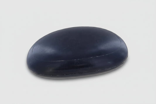 Savon galet noir naturel KAVERN au charbon actif purifiant et lait d'avoine apaisant. Un soin spa détox pour nettoyer la peau en profondeur sans l'assécher.